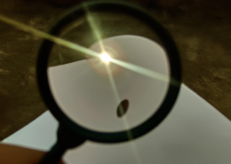 Magnifying glass concentrating the sun's rays onto a sheet of paper